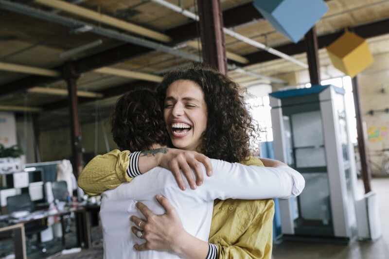 Two friends hugging each other 