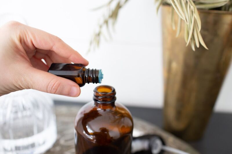 Adding essential oils to a DIY linen spray for better sleep. 