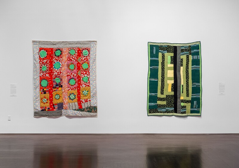 Two quilts by African American quilt artists hang as works of art in the Blanton Museum of Art in Austin, TX. The quilt on the left is by Arie Pettway and Sally Mae Pettway -- both emerging from the Gee's Bend quilting community in Alabama. 