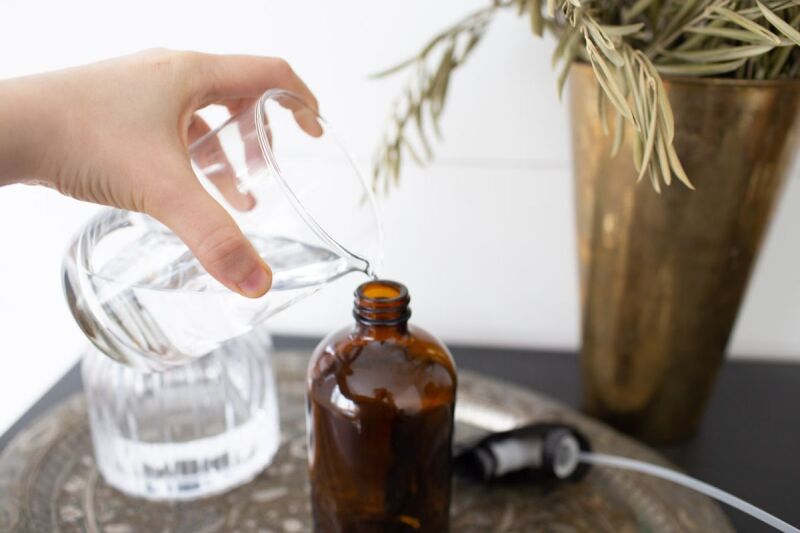 Using water and vodka to create a DIY linen spray for better rest. 