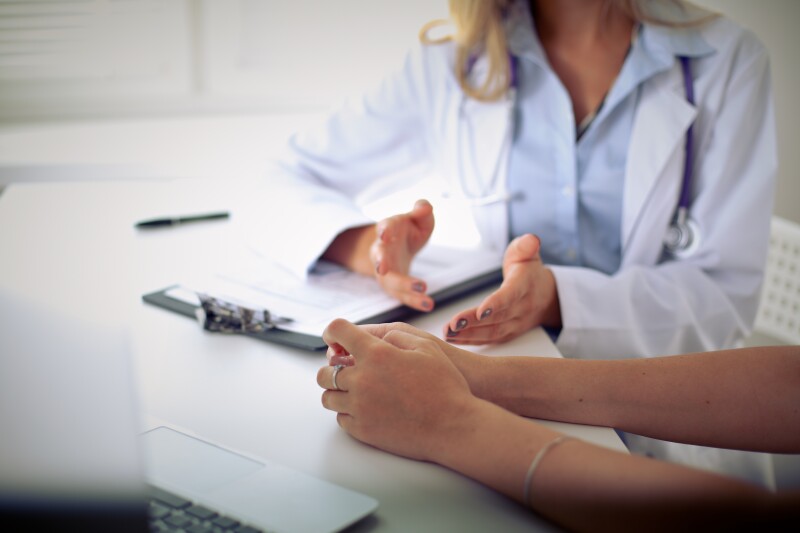 Woman consulting with her doctor about sleep and vaccines