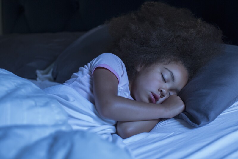 Little child asleep on their own after bedtime, thanks to sleep training